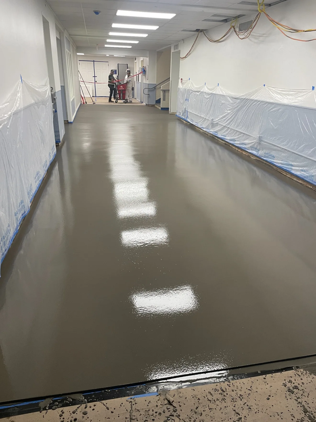 Self-leveling underlayment poured across a large interior area at Texas A&M University in College Station, Texas.