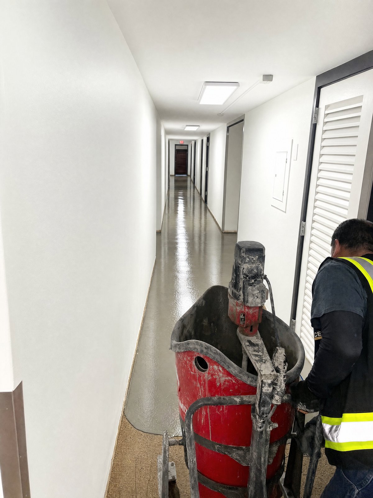 Pace Coatings crew applying a self-leveling floor in a corridor, Houston TX